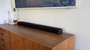 Polk Signia S4 sound bar at an angle on wood credenza.
