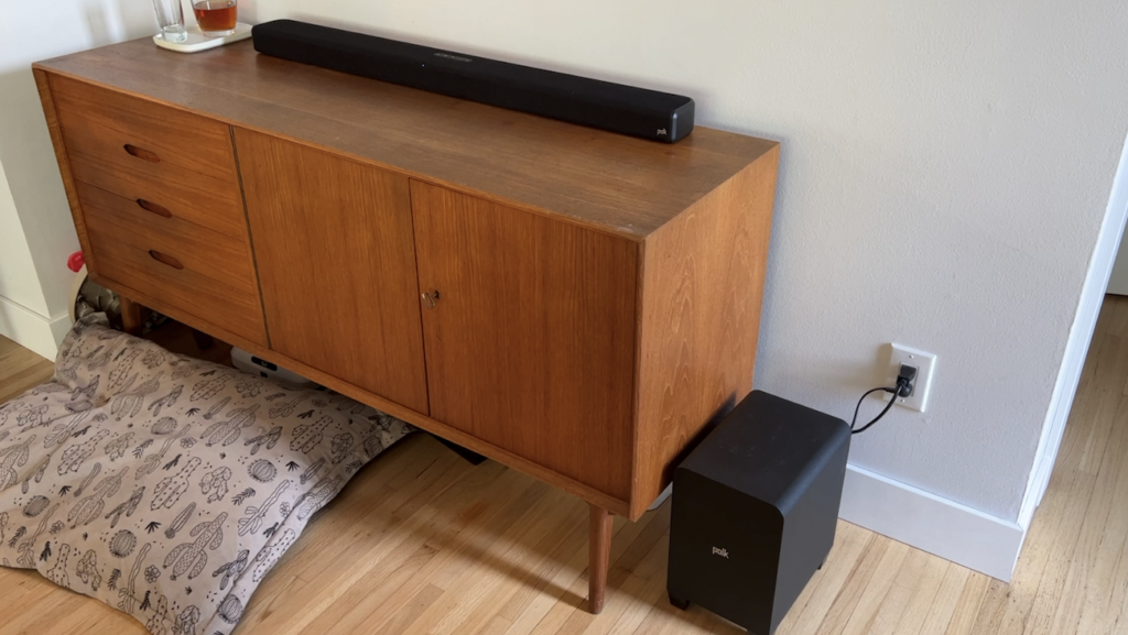 S4 sound abr on furniture with subwoofer on the floor beside it.